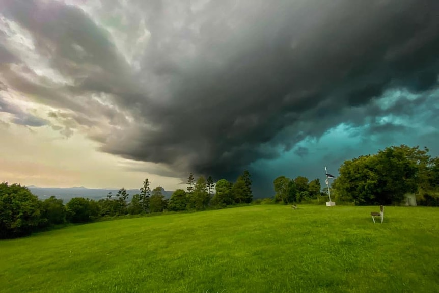A black and green storm cloud in the distance
