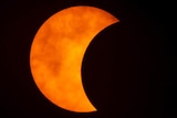 A photo shows a partial solar eclipse observed in Bangkok, Thailand.