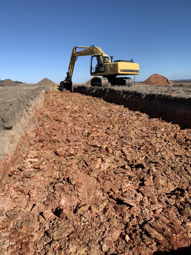 Trench with excavator. 