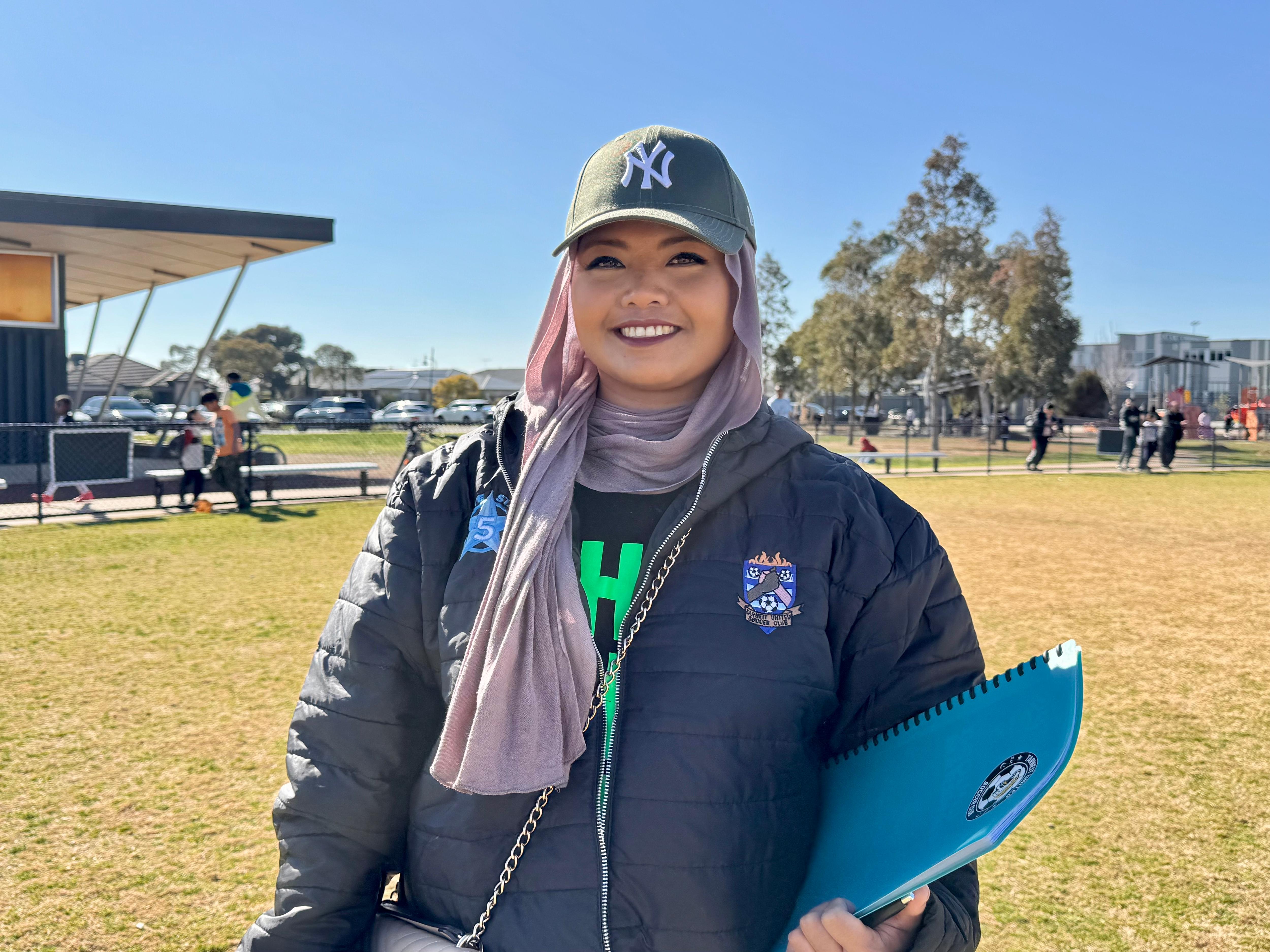 Nyx Ahmed smiles at the camera.