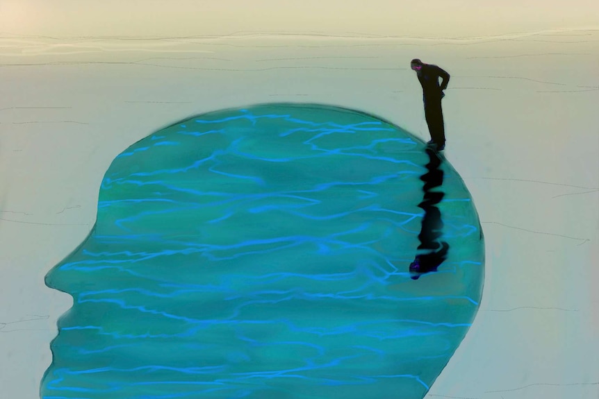 Male figure looking into pool of water in shape of a head