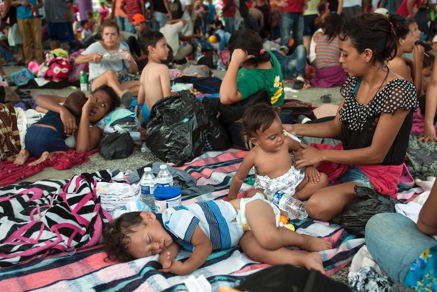 A group of migrants resting with their babies.