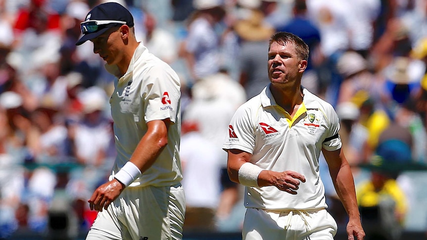 Australia's David Warner talks with England's Tom Curran on day one at MCG on December 26, 2017.