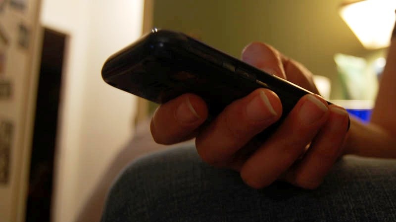 Person holds a mobile phone.