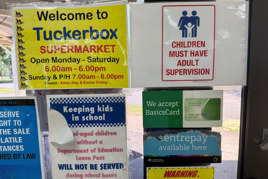 various signs on a door explaining children without an adult aren't allowed in