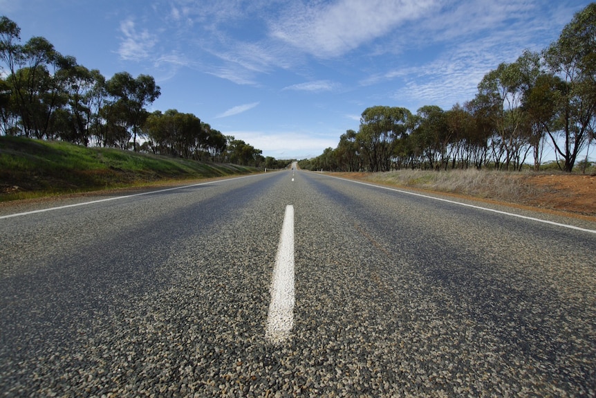 Great Eastern Highway near Northam stretches into the distance under a blue sky