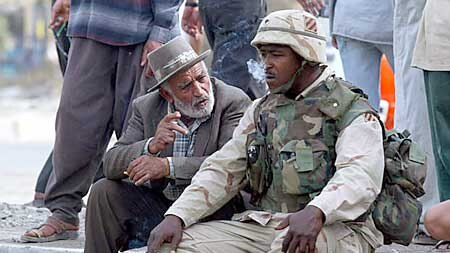 Man chats with US soldier at Baghdad checkpoint. (Reuters: Gleb Garanich)