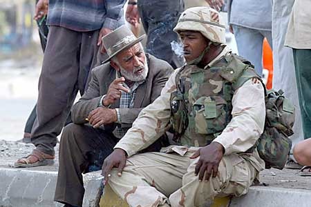 Man chats with US soldier at Baghdad checkpoint. (Reuters: Gleb Garanich)