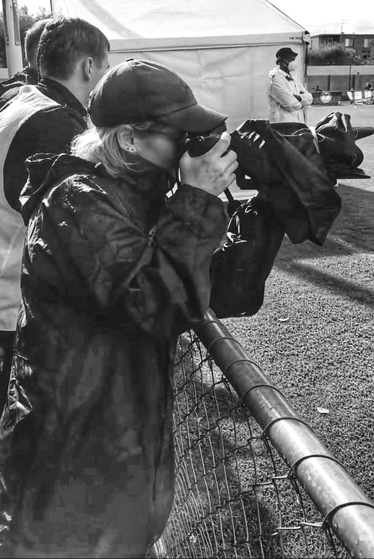 Cat Bryant shoots from from the sidelines in wet weather.