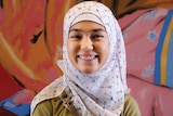 Rahila smiles in front of a patterned background for a story about befriending different people to you and its benefits.