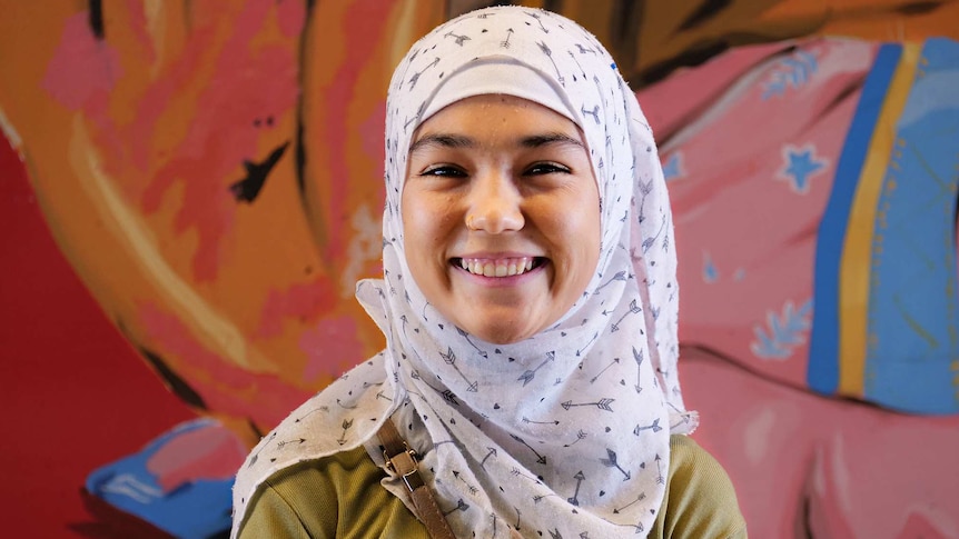 Rahila smiles in front of a patterned background for a story about befriending different people to you and its benefits.