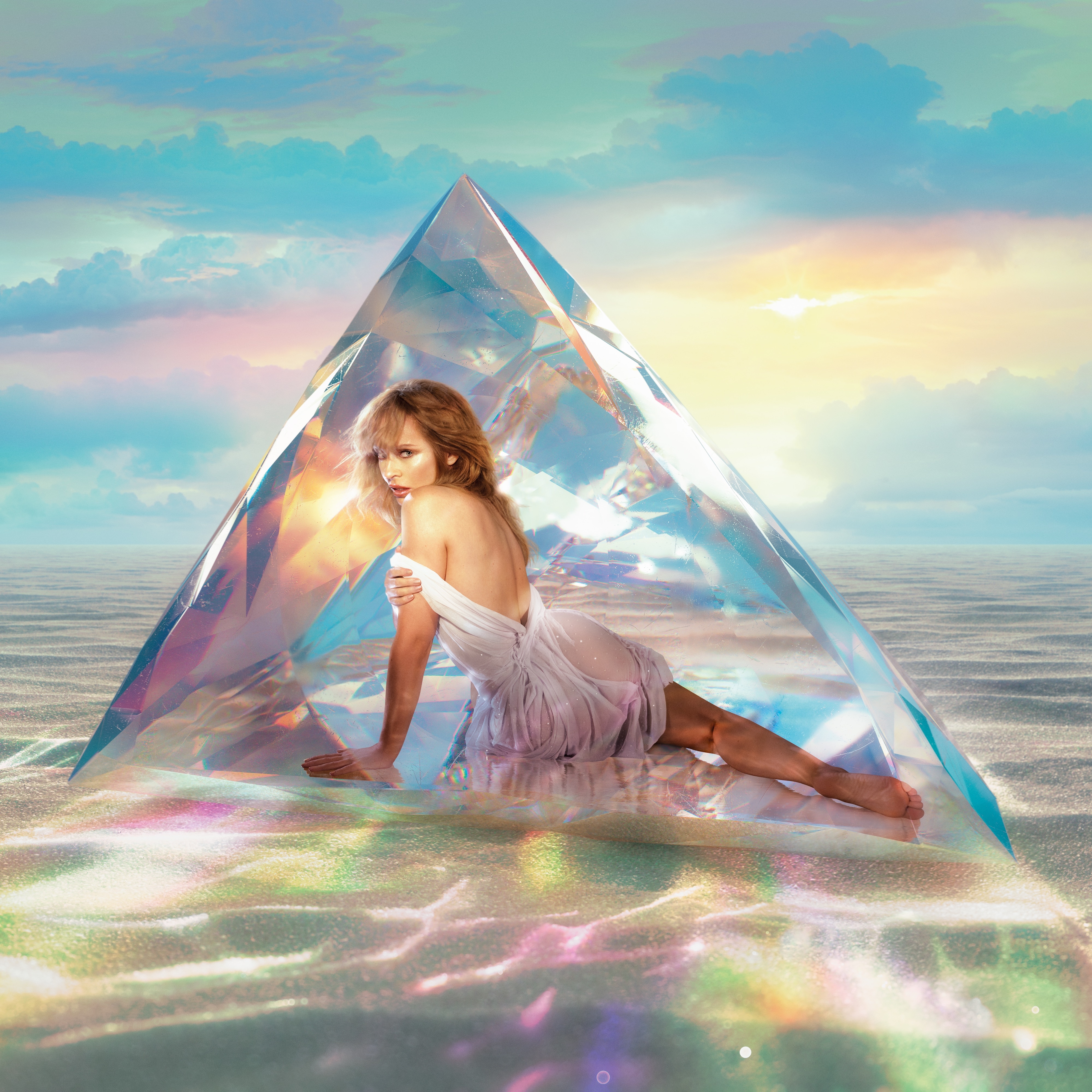 Kylie in a white shimmery dress infront of a glacial like prism.