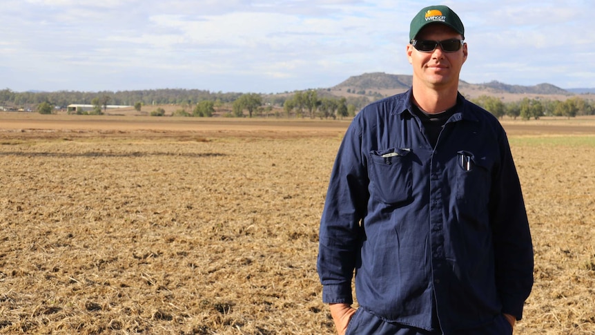 Vegetable farmer Steve Kluck stands in a dry, empty paddock.