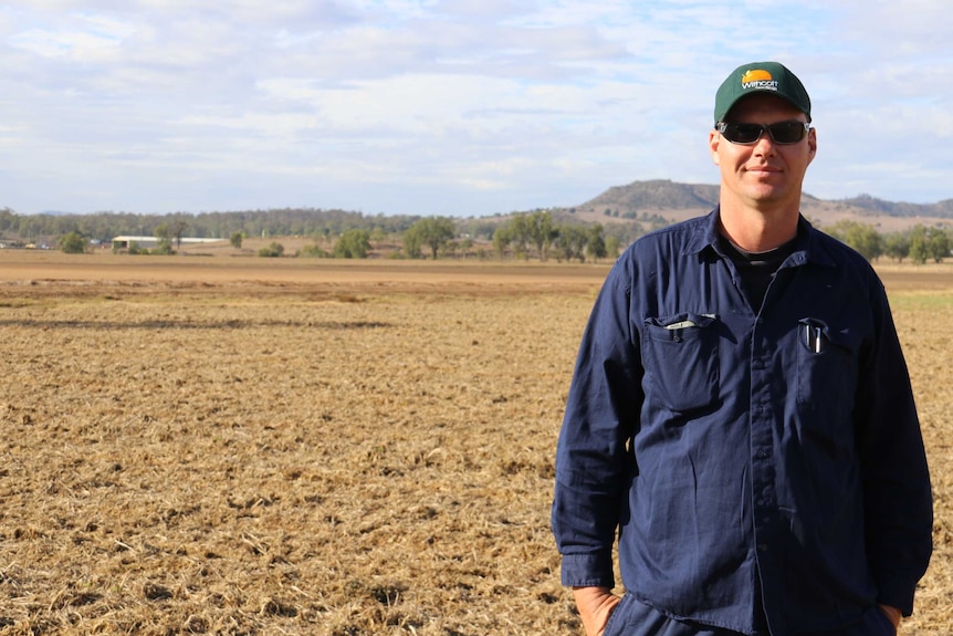 Vegetable farmer Steve Kluck stands in a dry, empty paddock.