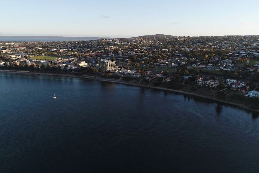 Drone pic and bird's-eye view looking down on the Port Lincoln city with buildings and sea.