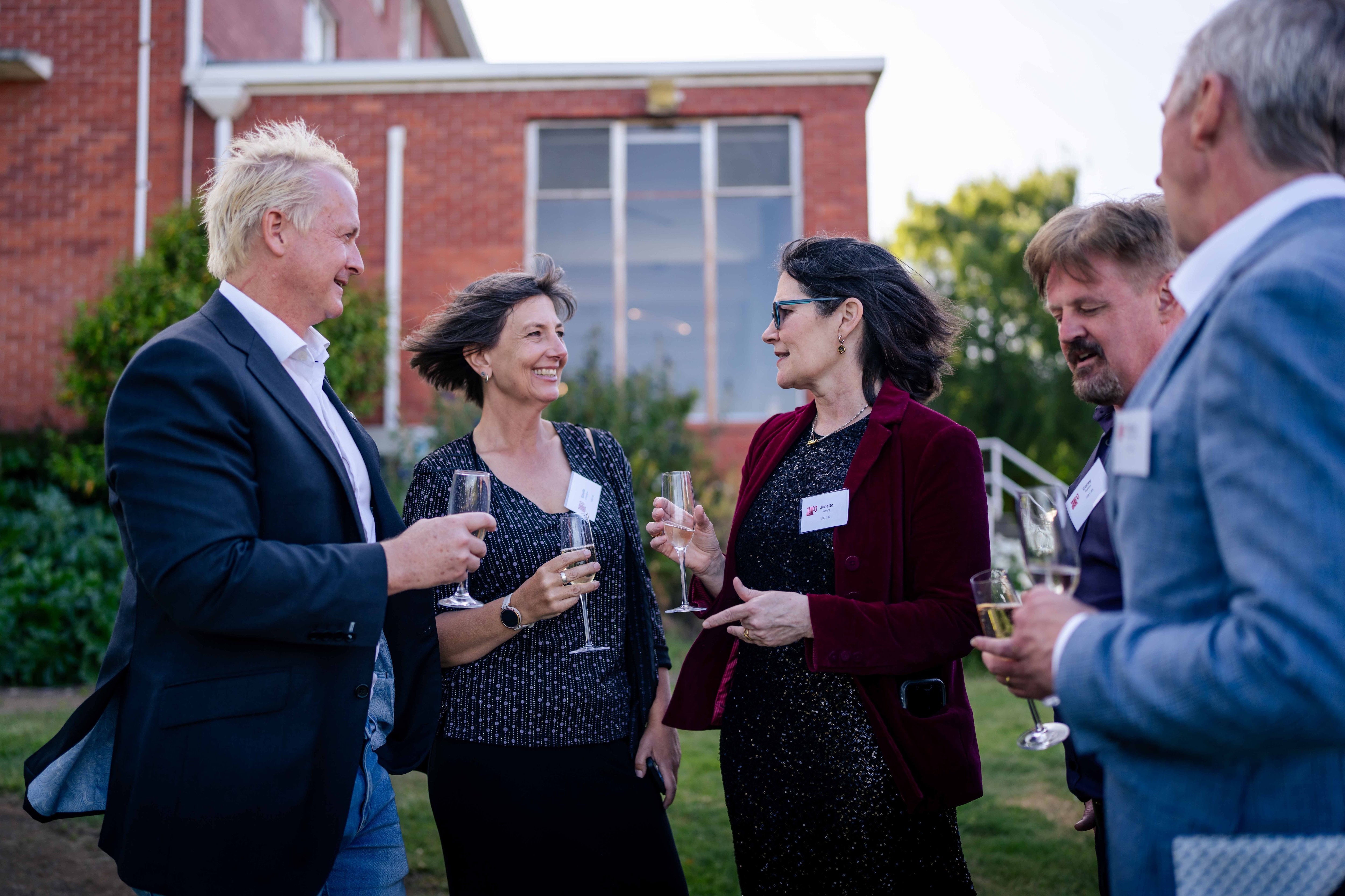 A group of friends outside with champagne glasses