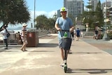 A man on an electric scooter in Surfers Paradise