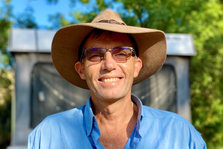 A man in an Akubra-style hat and a blue-collared shirt. 