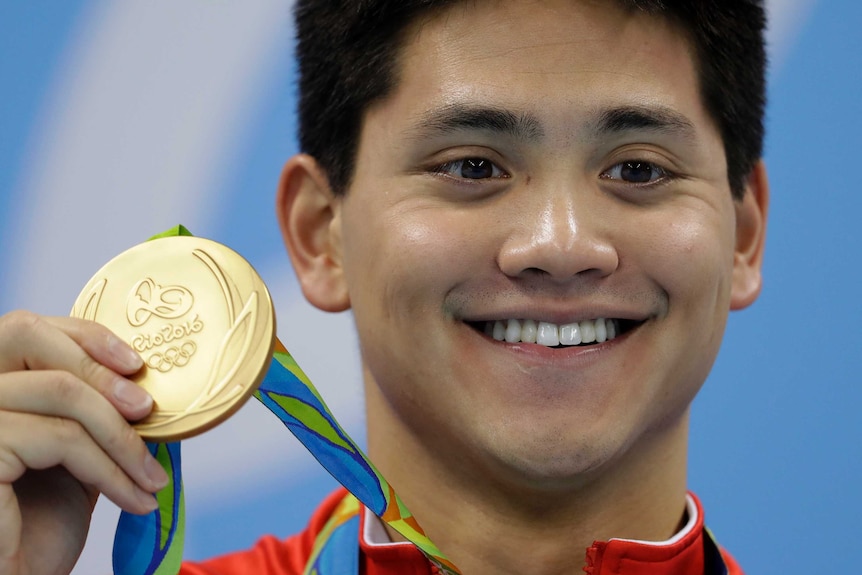 Joseph Schooling with Singapore's first Olympic gold medal