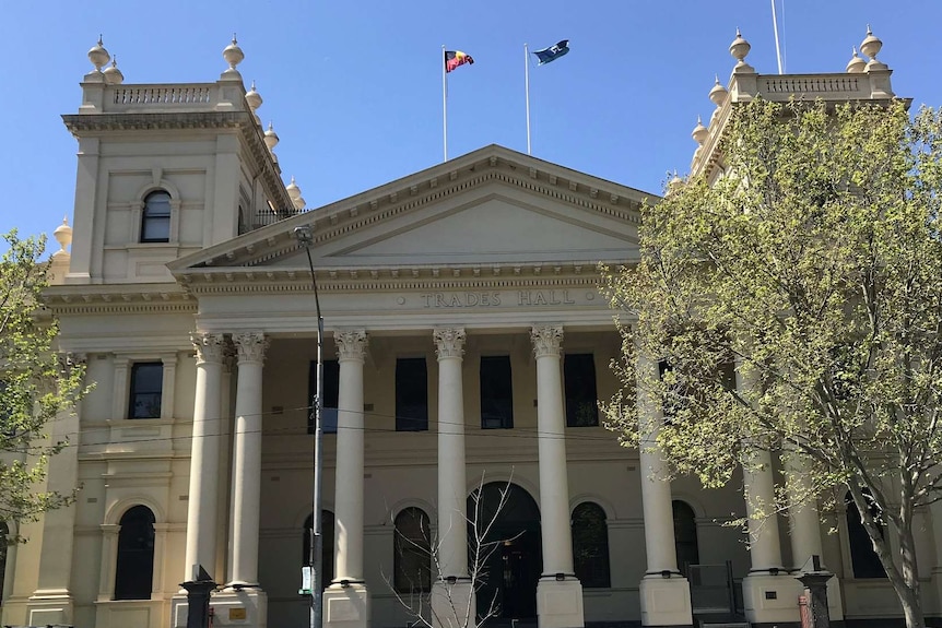 The front of Trades Hall in Melbourne, a large cream-coloured building.