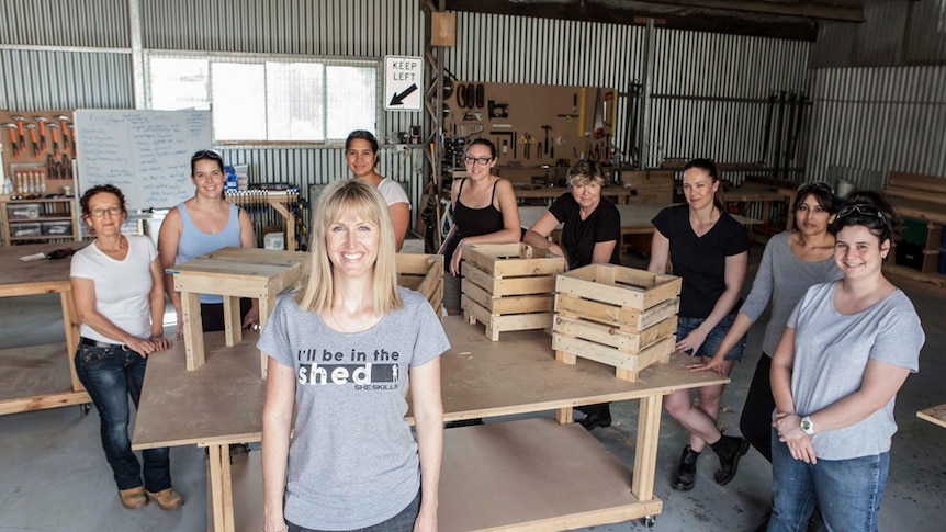 Women in a workshop building planter boxes.
