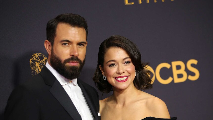 The couple wear black and smile on the red carpet