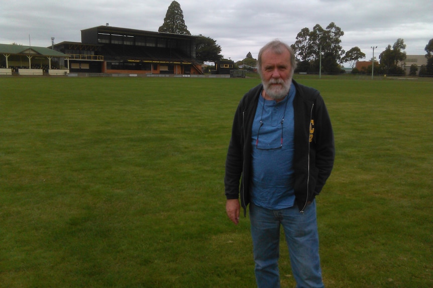 Martin Flanagan stands in an empty football field