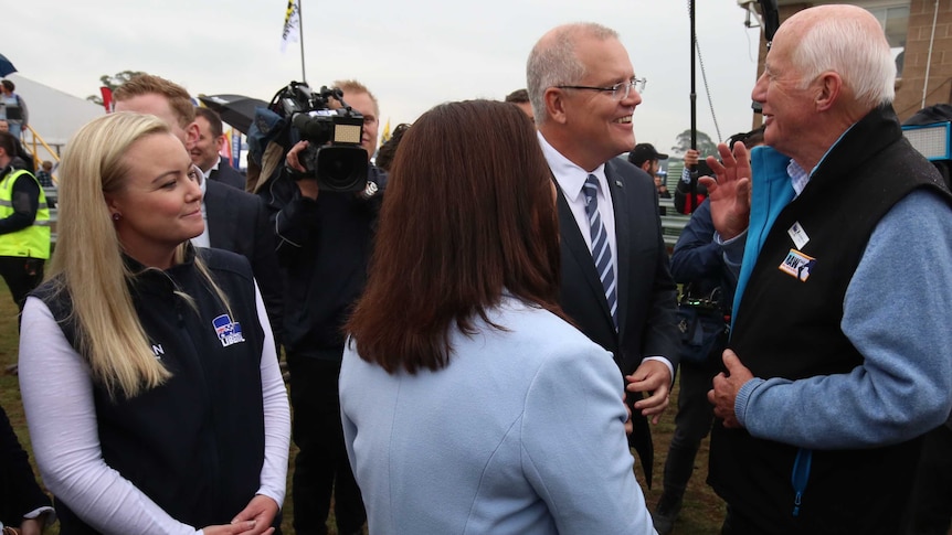 Jessica Whelan and Prime Minister Scott Morrison speak to locals in Tasmania during a federal election campaign visit.