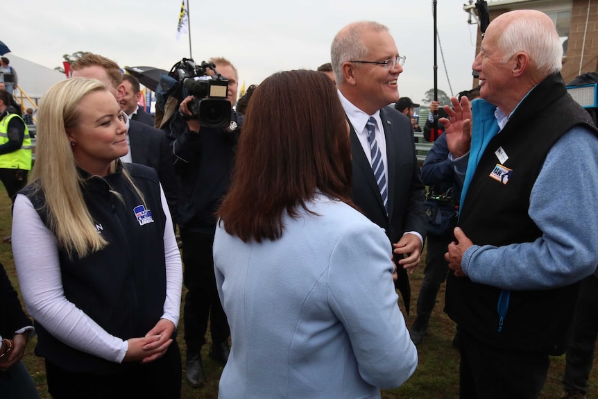 Jessica Whelan and Prime Minister Scott Morrison speak to locals in Tasmania during a federal election campaign visit.