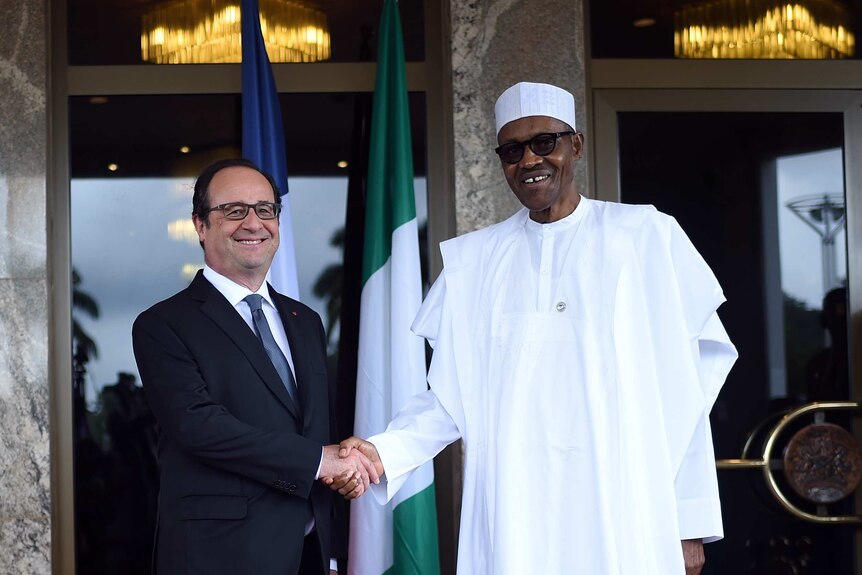 French President Francois Hollande shakes hands with his Nigerian counterpart Muhammadu Buhari