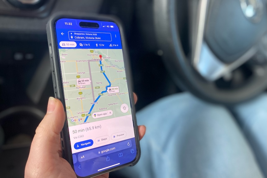 hand holding phone displaying navigation map