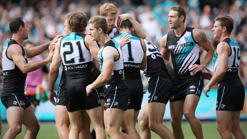 Port Adelaide players celebrate a goal against St Kilda at Adelaide Oval