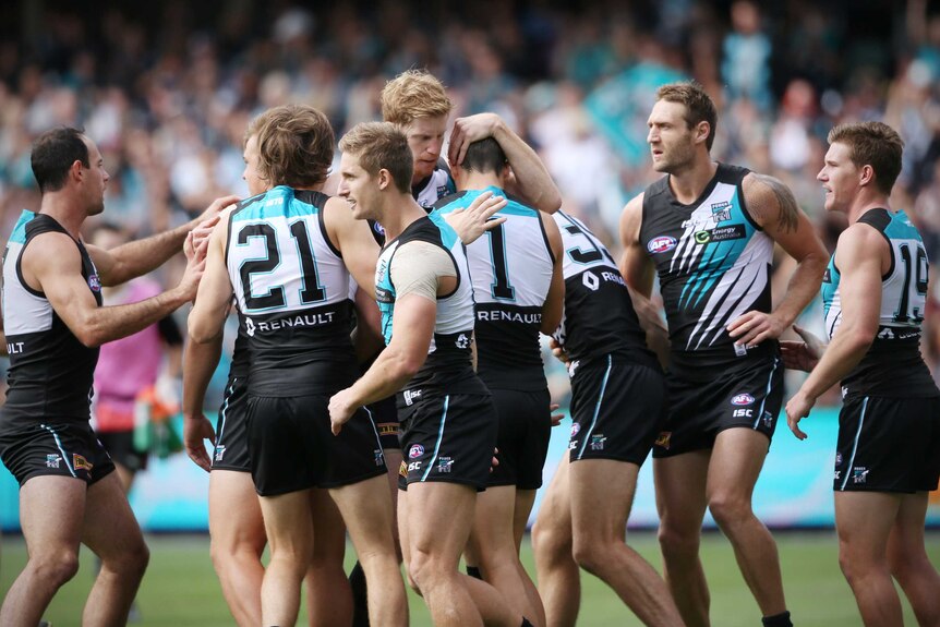 Port Adelaide players celebrate a goal against St Kilda at Adelaide Oval