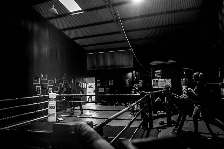 A boxing gym in black and white with little light 