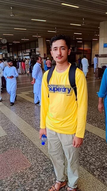 man in yellow shirt and backpack