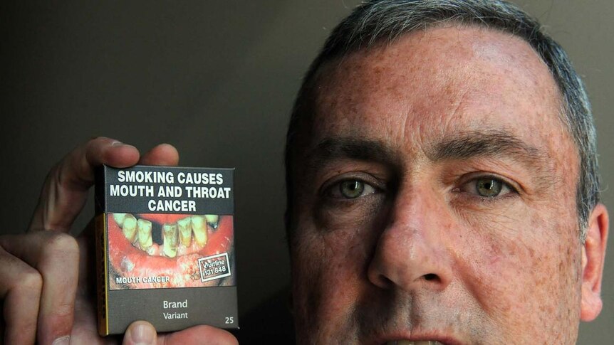 All cigarettes will be sold in olive-green cigarette packets plastered with graphic health warnings under the new legislation.