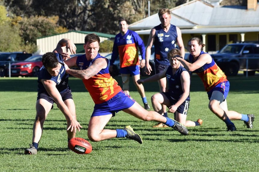 Football players go in for the ball.