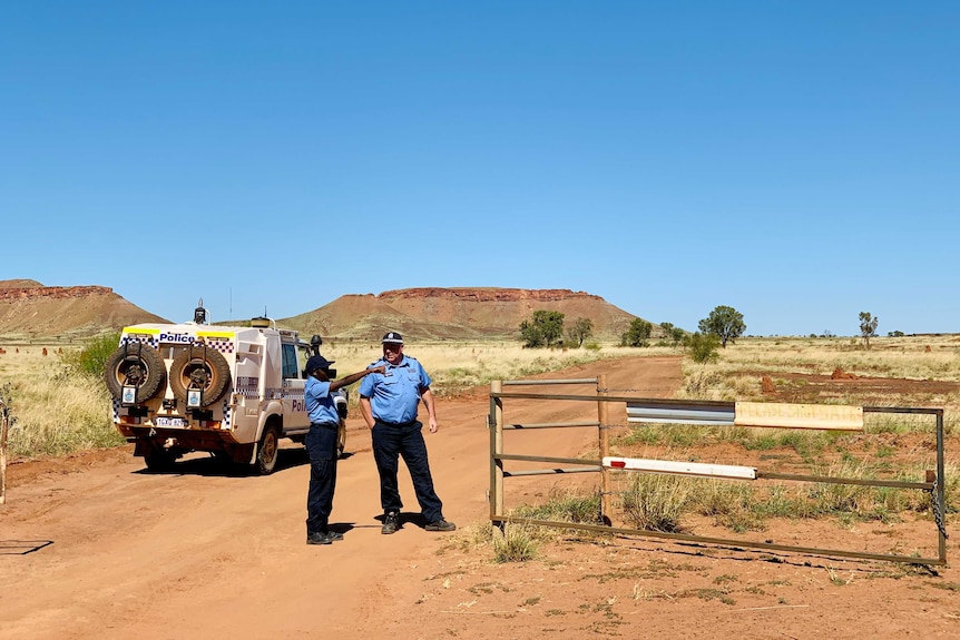 Police patrol in a desert landscape.