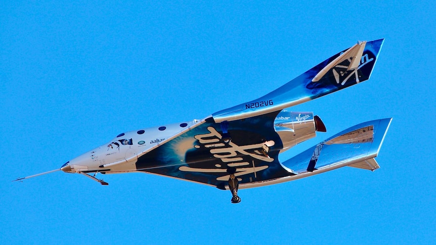 a white and blue spaceship flies above the earth