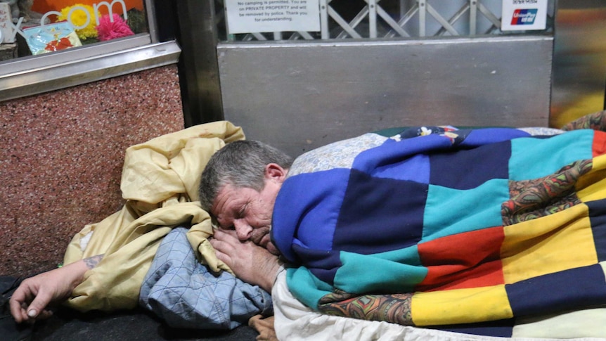 A homeless person sleeping rough.