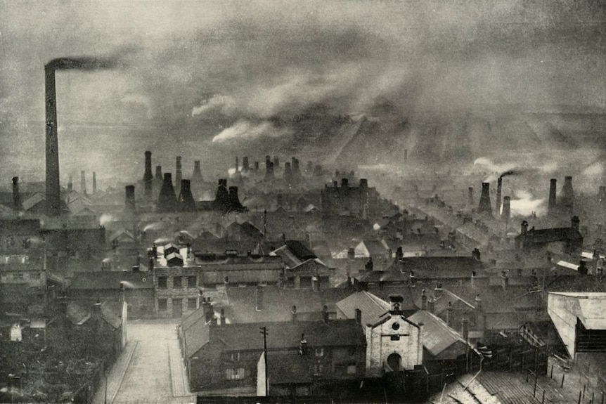 A black and white illustration of factories spewing smoke in England in the 1930s.
