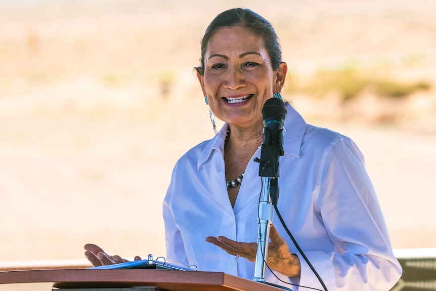 US Secretary of the Interior Deb Haaland speaks from a podium.