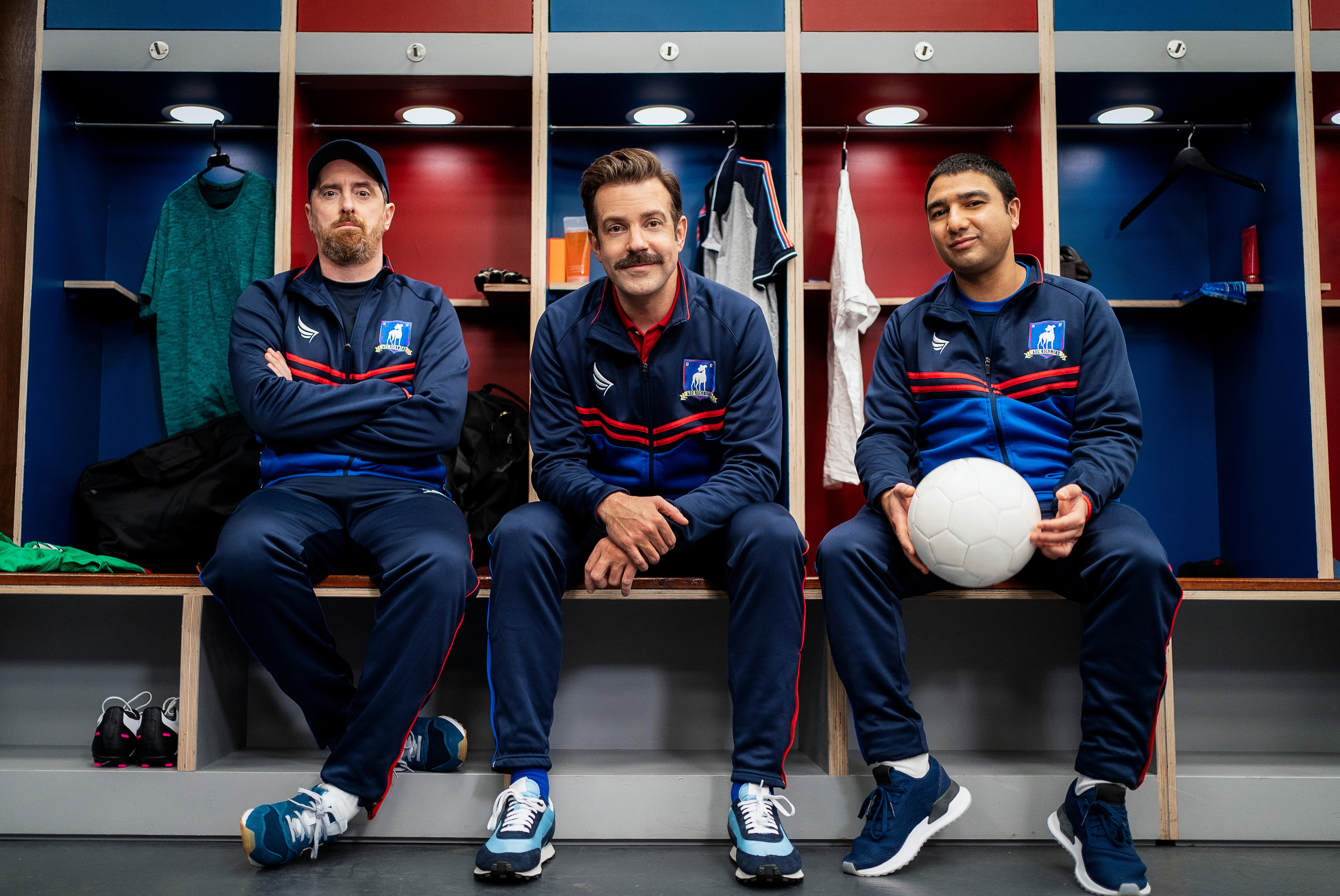 Brendan Hunt, Jason Sudeikis and Nick Mohammed sit in a locker room.