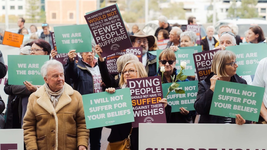 Voluntary euthanasia supporter holds a "My Life, My Choice" sign.