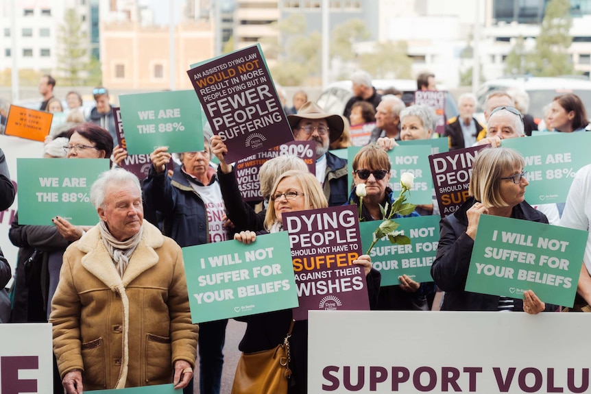 Voluntary euthanasia supporter holds a "My Life, My Choice" sign.