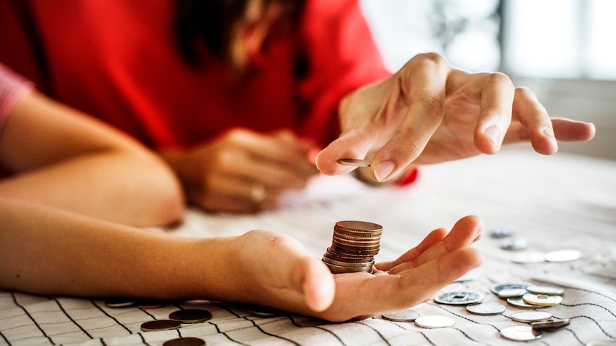 Couple count coins in their hands.