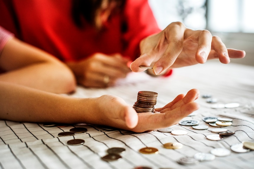 Couple count coins in their hands.