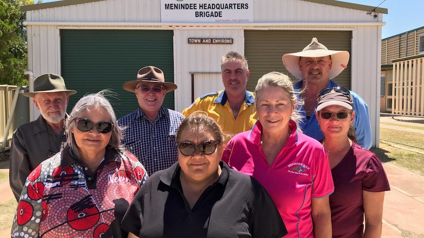 Eight of the newest members of the Menindee RFS standing out the front of the unit.
