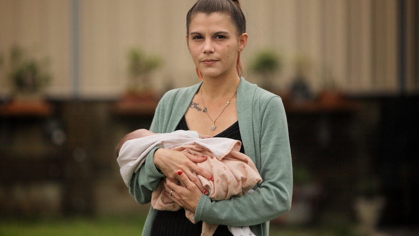 Amie Rabinski  holds her baby.