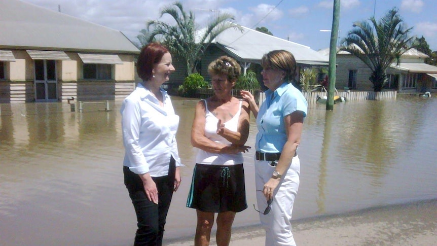 Anna Bligh and Julia Gillard speak with a flood-affected Bundaberg resident